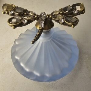 Vintage blue glass perfume bottle with a dragonfly on the top of the‎ stopper